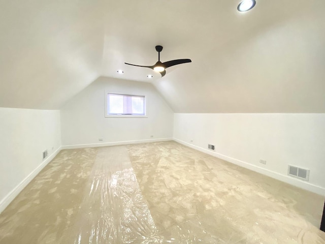 bonus room with vaulted ceiling, light colored carpet, baseboards, and visible vents