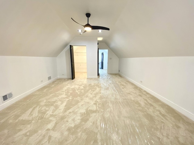 additional living space featuring visible vents, baseboards, and light carpet
