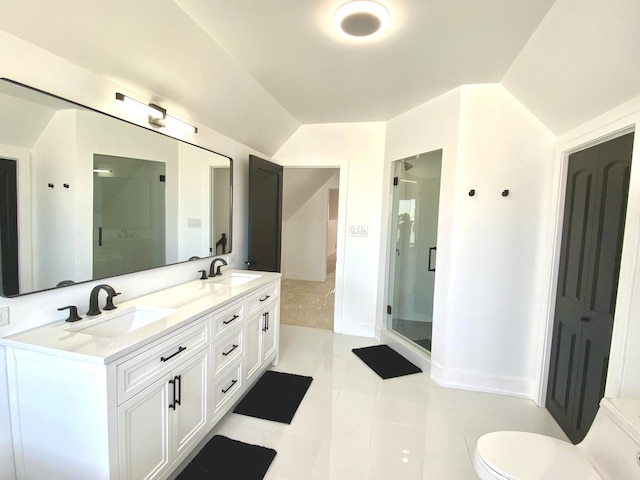 bathroom with a stall shower, lofted ceiling, double vanity, and a sink
