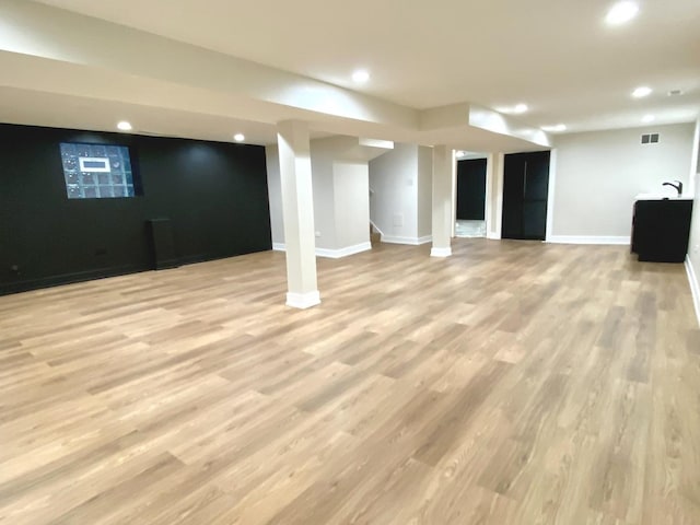 finished basement featuring wood finished floors, visible vents, baseboards, and recessed lighting
