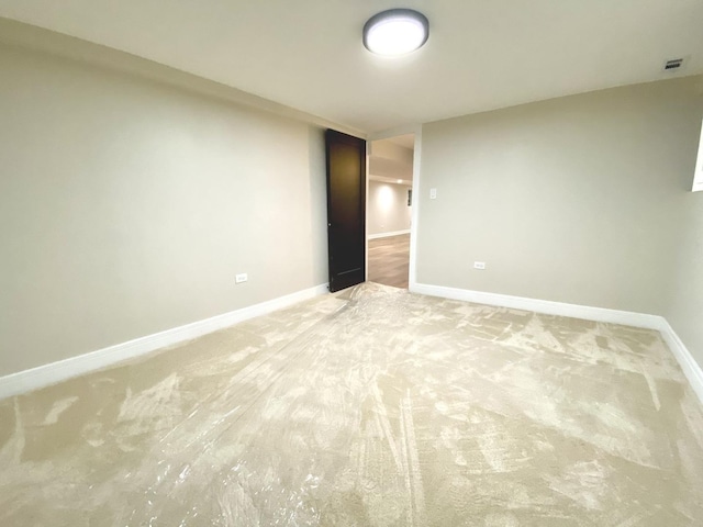 unfurnished room featuring light carpet, baseboards, and visible vents