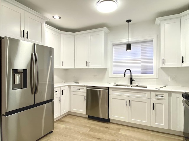 kitchen featuring a sink, white cabinets, and appliances with stainless steel finishes