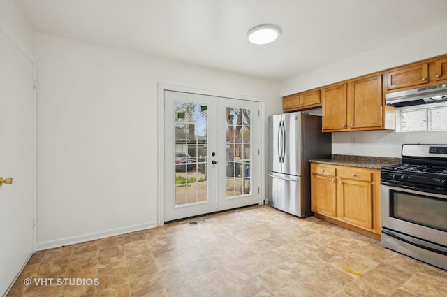 kitchen with stainless steel appliances, french doors, visible vents, under cabinet range hood, and dark countertops