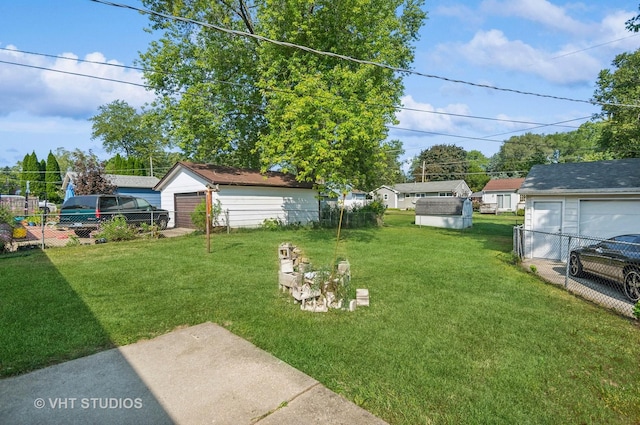 view of yard featuring a garage and fence