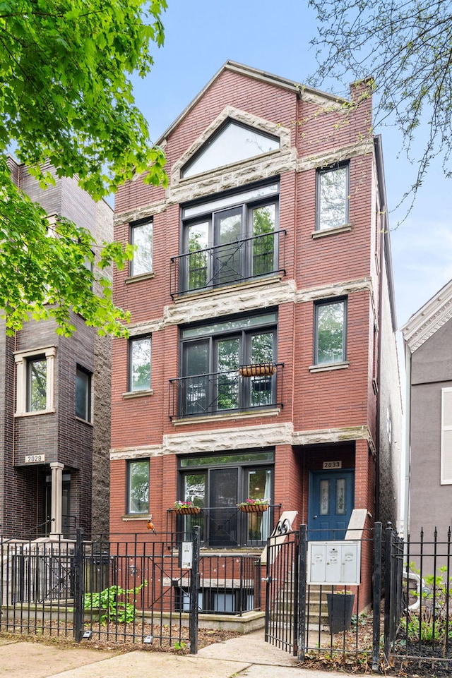 2033 W Rice St Unit 3, Chicago, IL 60622 - view of front of house featuring a fenced front yard and brick siding