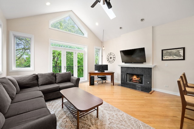 2033 W Rice St Unit 3, Chicago, IL 60622 - living area with light wood finished floors, ceiling fan, a fireplace with flush hearth, a skylight, and high vaulted ceiling