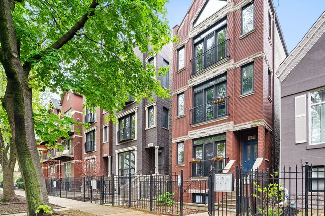 2033 W Rice St Unit 3, Chicago, IL 60622 - view of building exterior featuring a fenced front yard