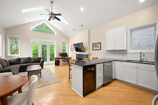 2033 W Rice St Unit 3, Chicago, IL 60622 - kitchen with a sink, open floor plan, a skylight, dishwasher, and a peninsula