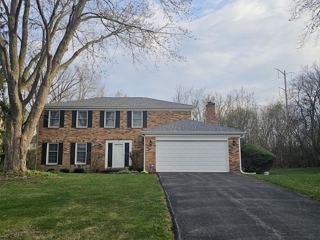 81 W N Ave, Lake Forest, IL 60045 - colonial inspired home featuring a chimney, a front yard, an attached garage, and driveway