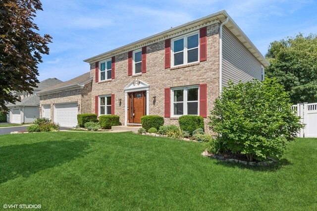 2020 Saint Andrews Dr, Plainfield, IL 60586 - view of front facade featuring an attached garage, brick siding, and asphalt driveway