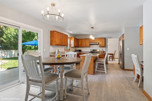 2020 Saint Andrews Dr, Plainfield, IL 60586 - dining area with a chandelier and light wood finished floors