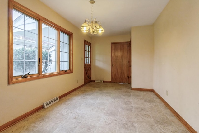 618 Russell Rd, Dekalb, IL 60115 - unfurnished room featuring a chandelier and baseboards