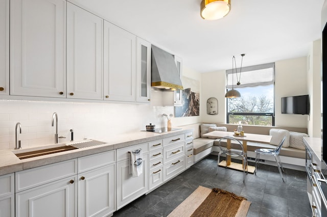 1040 N Lake Shore Dr Unit 4C, Chicago, IL 60611 - kitchen with wall chimney range hood, decorative backsplash, black electric cooktop, and white cabinets