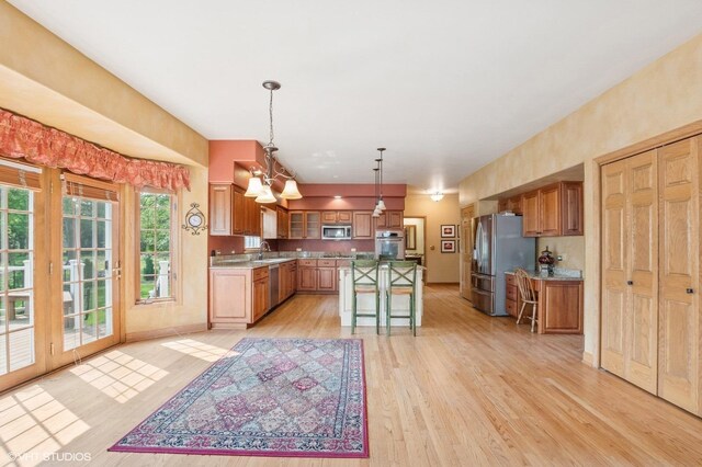1373 Notre Dame Dr, Lemont, IL 60439 - kitchen featuring stainless steel appliances, a sink, light wood finished floors, a chandelier, and a kitchen island