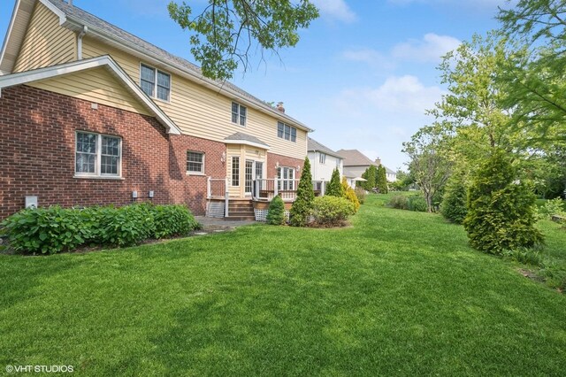 1373 Notre Dame Dr, Lemont, IL 60439 - back of house featuring brick siding, a yard, a deck, and a chimney