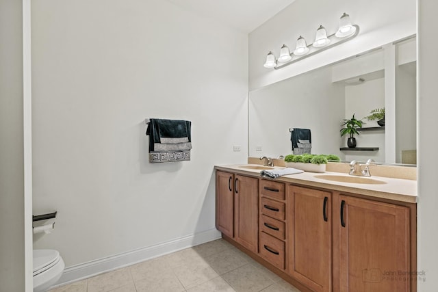 full bathroom with baseboards, toilet, double vanity, and tile patterned floors