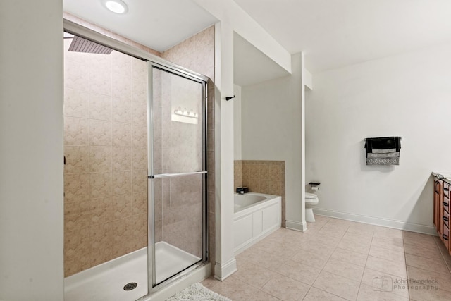 bathroom with a shower stall, tile patterned floors, baseboards, a garden tub, and toilet