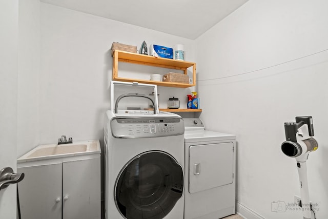 washroom featuring washer and clothes dryer and cabinet space