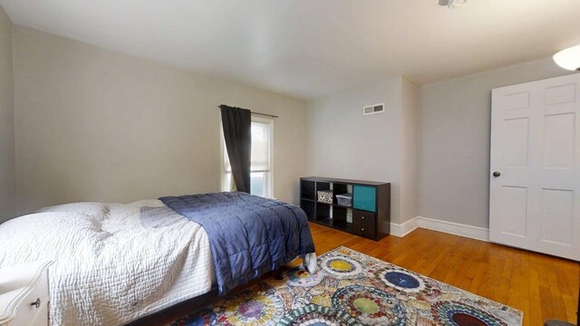 1013 W Springfield Ave, Champaign, IL 61821 - bedroom with wood finished floors and baseboards