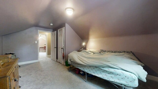 1013 W Springfield Ave, Champaign, IL 61821 - bedroom featuring light carpet, vaulted ceiling, and baseboards