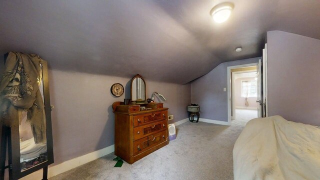 1013 W Springfield Ave, Champaign, IL 61821 - bedroom featuring light colored carpet, lofted ceiling, and baseboards