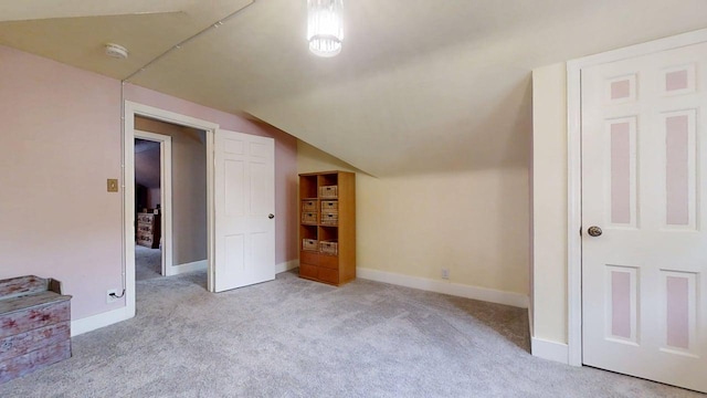 1013 W Springfield Ave, Champaign, IL 61821 - bonus room with carpet flooring, lofted ceiling, and baseboards