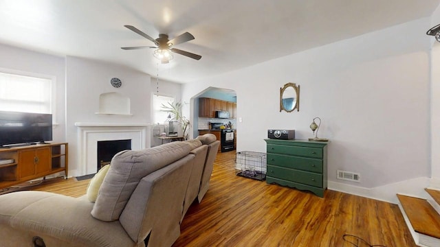 1013 W Springfield Ave, Champaign, IL 61821 - living room with a fireplace, ceiling fan, arched walkways, and wood finished floors
