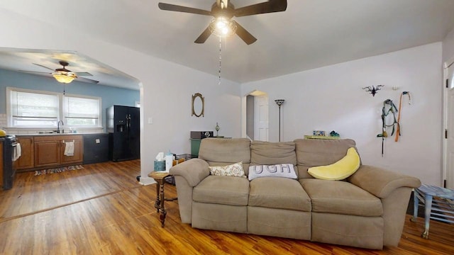 1013 W Springfield Ave, Champaign, IL 61821 - living area with a ceiling fan, arched walkways, and light wood finished floors