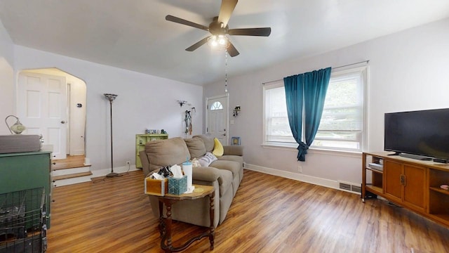 1013 W Springfield Ave, Champaign, IL 61821 - living room featuring ceiling fan, wood finished floors, baseboards, and arched walkways