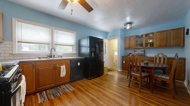 1013 W Springfield Ave, Champaign, IL 61821 - kitchen featuring black appliances, wood finished floors, a sink, brown cabinetry, and ceiling fan