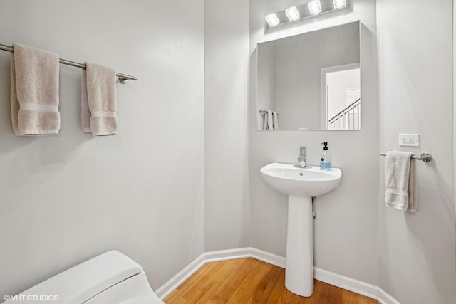 62 Andover Cir, Northbrook, IL 60062 - half bathroom with baseboards, wood finished floors, and toilet