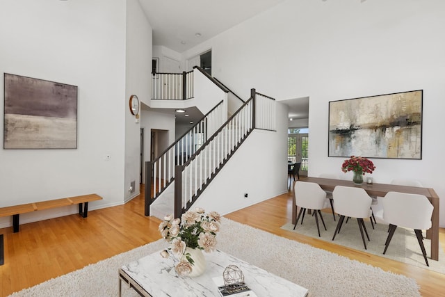 62 Andover Cir, Northbrook, IL 60062 - living room featuring a high ceiling, wood finished floors, stairs, and baseboards