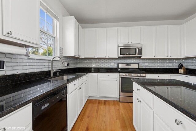 62 Andover Cir, Northbrook, IL 60062 - kitchen featuring appliances with stainless steel finishes, a sink, white cabinets, and dark stone countertops
