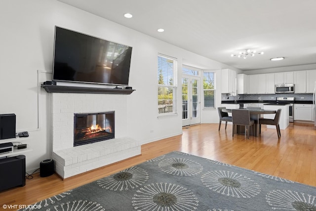 62 Andover Cir, Northbrook, IL 60062 - living room with light wood finished floors, a brick fireplace, and recessed lighting