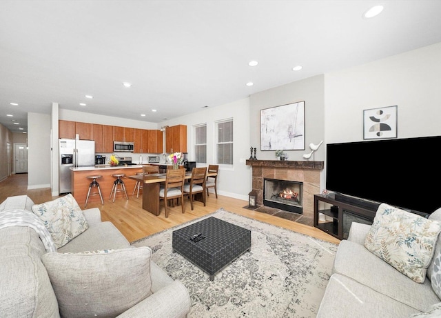 2158 N Natchez Ave Unit 1N, Chicago, IL 60707 - living room with recessed lighting, a tile fireplace, baseboards, and light wood-style floors