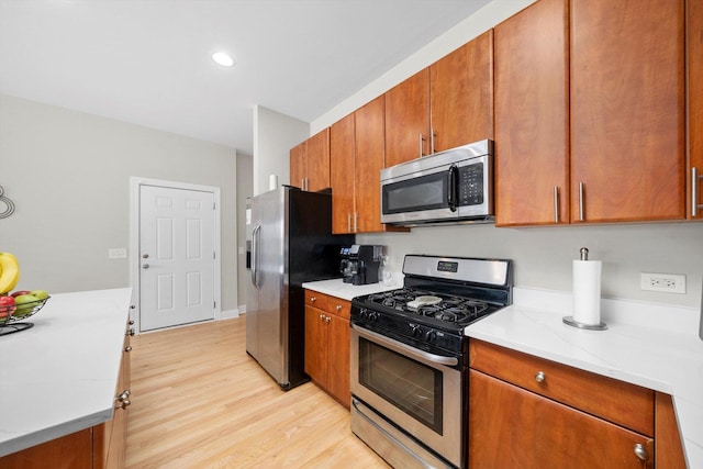 2158 N Natchez Ave Unit 1N, Chicago, IL 60707 - kitchen featuring brown cabinetry, stainless steel appliances, light countertops, and light wood-style flooring