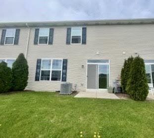 back of property featuring a yard