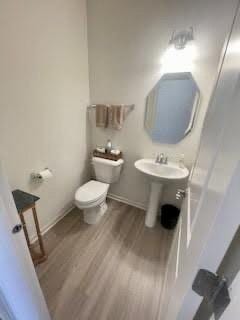 bathroom featuring toilet and wood finished floors