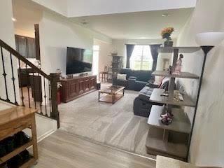 living room featuring stairway and wood finished floors