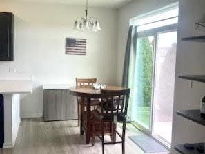 dining room with a chandelier and wood finished floors