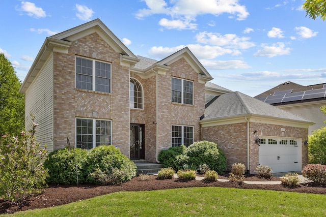 traditional-style house featuring brick siding, a garage, roof with shingles, and a front lawn