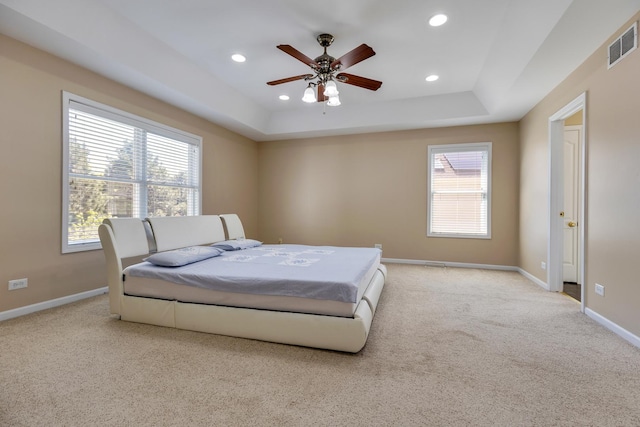 carpeted bedroom featuring baseboards, recessed lighting, a raised ceiling, and ceiling fan