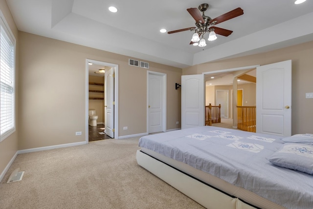 bedroom with light carpet, baseboards, recessed lighting, ensuite bathroom, and ceiling fan