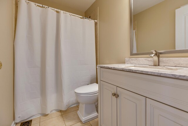 full bath featuring toilet, tile patterned floors, vanity, and curtained shower
