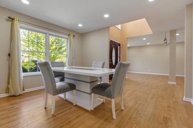 dining space with baseboards, light wood-style flooring, and recessed lighting