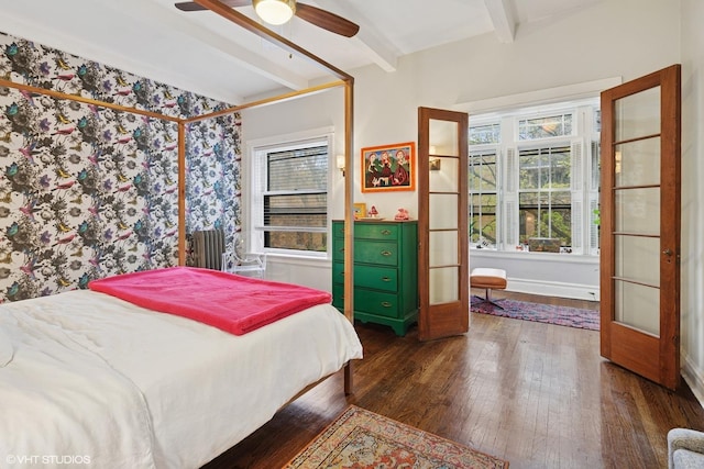 bedroom with a ceiling fan, beamed ceiling, and hardwood / wood-style flooring
