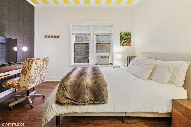 bedroom featuring baseboards, cooling unit, crown molding, and wood finished floors