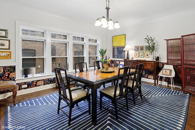 dining space with an inviting chandelier and wood finished floors
