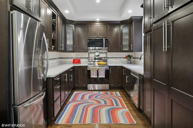 kitchen featuring recessed lighting, light countertops, appliances with stainless steel finishes, and a sink