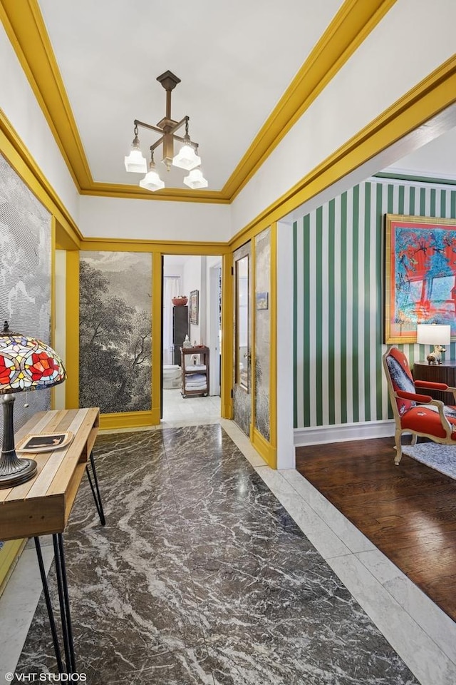 hallway with marble finish floor and crown molding